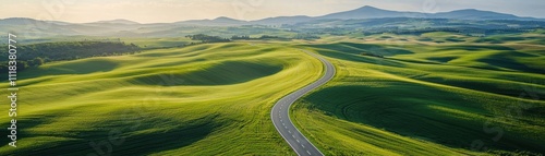 Scenic countryside view with winding road and green hills.