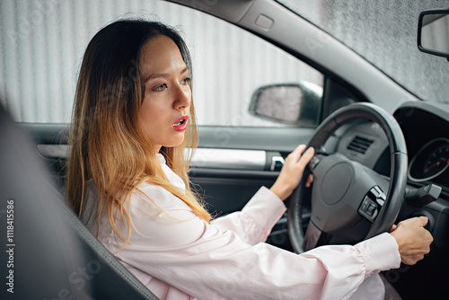 Car breakdown. An Asian woman tries to start a car. The car won't start. The driver turns the ignition key. The engine will not start.