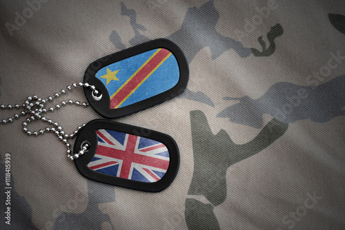 army blank, dog tag with national flag of democratic republic of the congo and great britain on the khaki texture background. military concept. photo