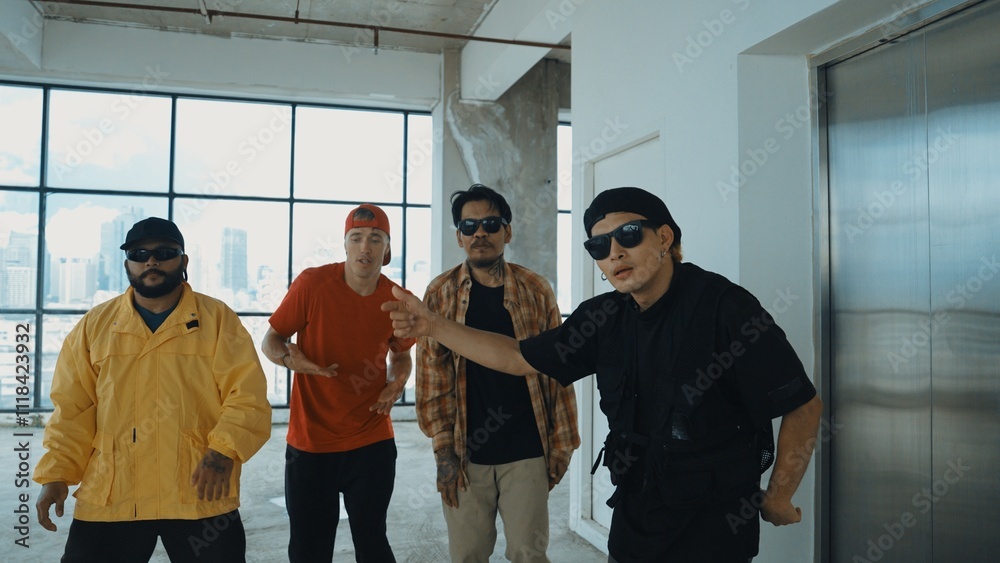 Obraz premium Multicultural dancer practice street dance and move to hip-hop music. Professional hipster group perform dance to freestyle music at building with sky scrapper view. Outdoor sport 2024. Hiphop.