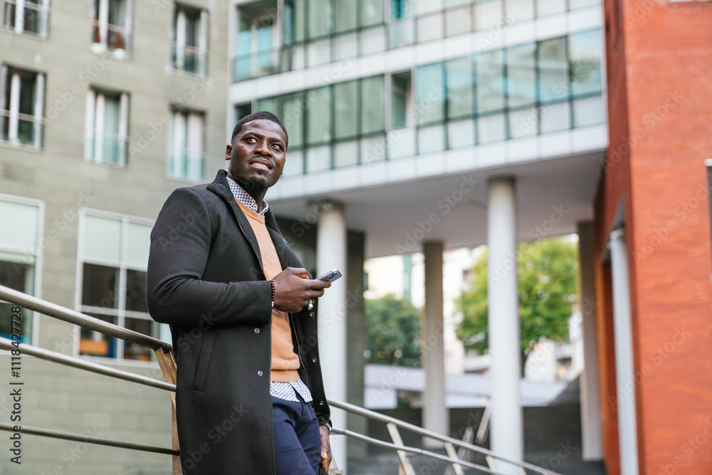 Young african business entrepreneur using smartphone in urban setting Young african business entrepreneur using smartphone in urban setting
