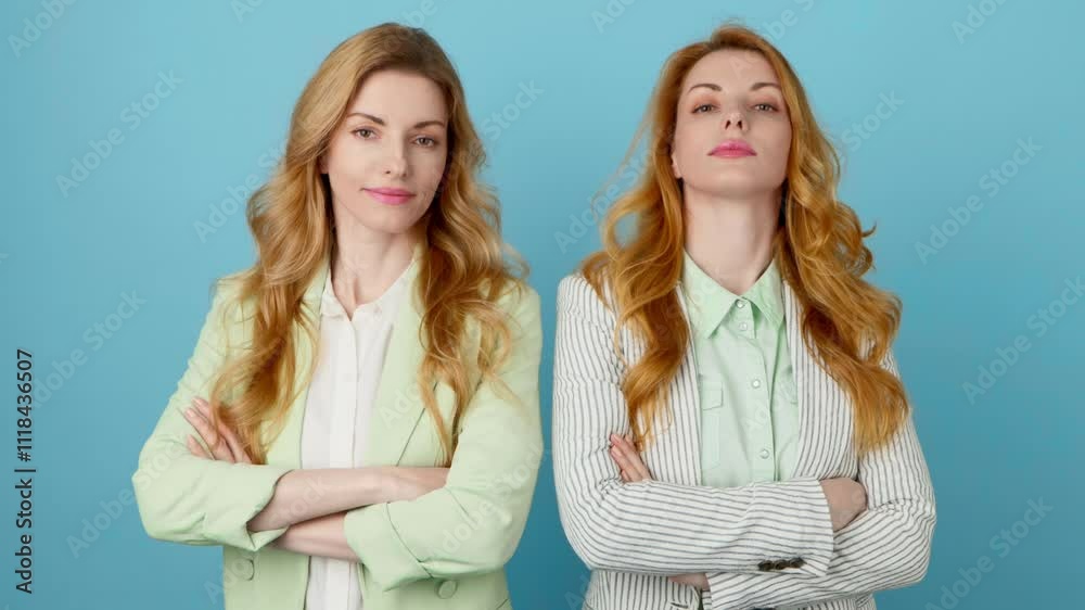 Fashionable friends, woman with smiling face for confidence, positivity, advert. Two women sister posing looking at camera, businesswoman pride emotion, trendy makeup, outfit on blue background Fashionable friends, woman with smiling face for confidence, positivity, advert. Two women sister posing looking at camera, businesswoman pride emotion, trendy makeup, outfit on blue background