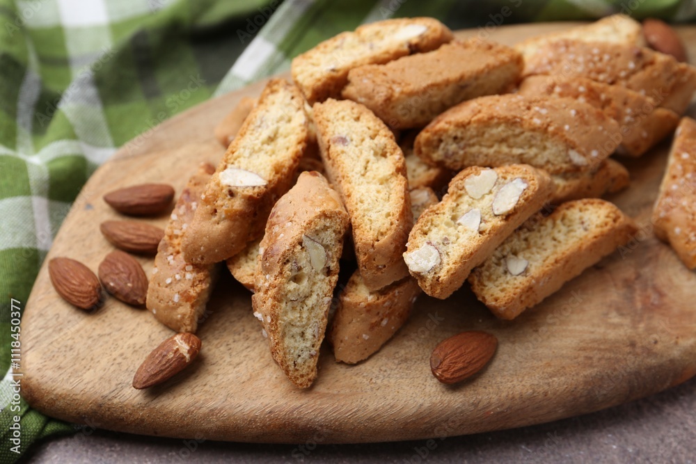 Tasty almond biscuits (Cantuccini) and nuts on table, closeup Tasty almond biscuits (Cantuccini) and nuts on table, closeup