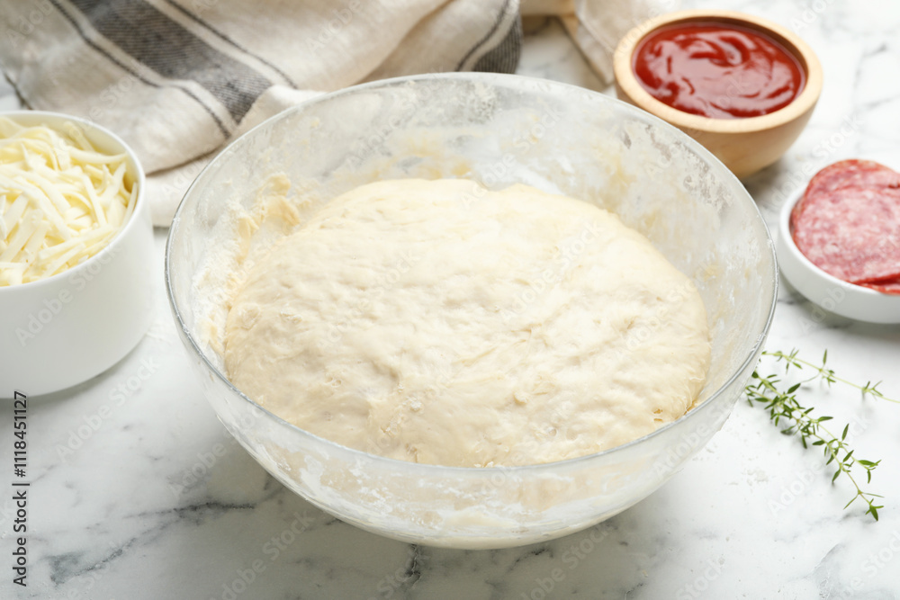Making calzone pizza. Different ingredients on white marble table, closeup Making calzone pizza. Different ingredients on white marble table, closeup