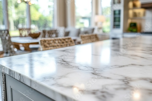 Modern kitchen with a marble countertop and a cozy dining area in the background.