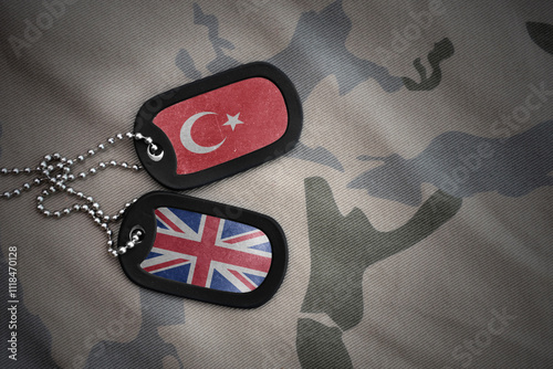 army blank, dog tag with national flag of turkey and great britain on the khaki texture background. military concept. photo