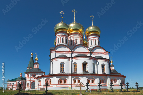 The architectural ensemble of the Valday Iversky monastery. Cathedral of the Assumption of the Iberian Mother of God and the monastery cemetery. Novgorod Region, Russia photo