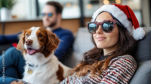 A woman in a Santa hat and sunglasses relaxes with her cheerful dog in a festive living room, capturing the joyful essence of the holiday season together. photo