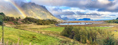 beautiful panoramic view with a rainbow in Norway with fjord background
