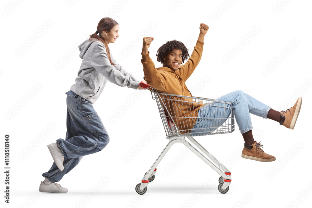 © Ljupco Smokovski - Female teenager pushing a young african american man seated in a shopping cart © Ljupco Smokovski - Female teenager pushing a young african american man seated in a shopping cart