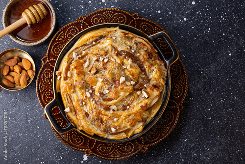 Phyllo pastry pie with pear, gorgonzola cheese, almond and honey, top view photo
