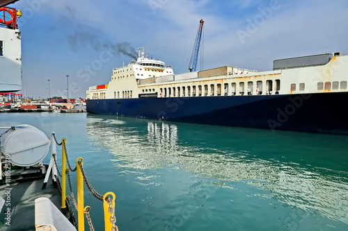  Various types of vessels calling at the port and moored at the berth. Tugs in the port. Mersin, Turkey,  2024 photo