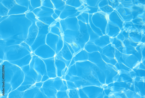 background of the turquoise blue pool water with light reflections and no other people