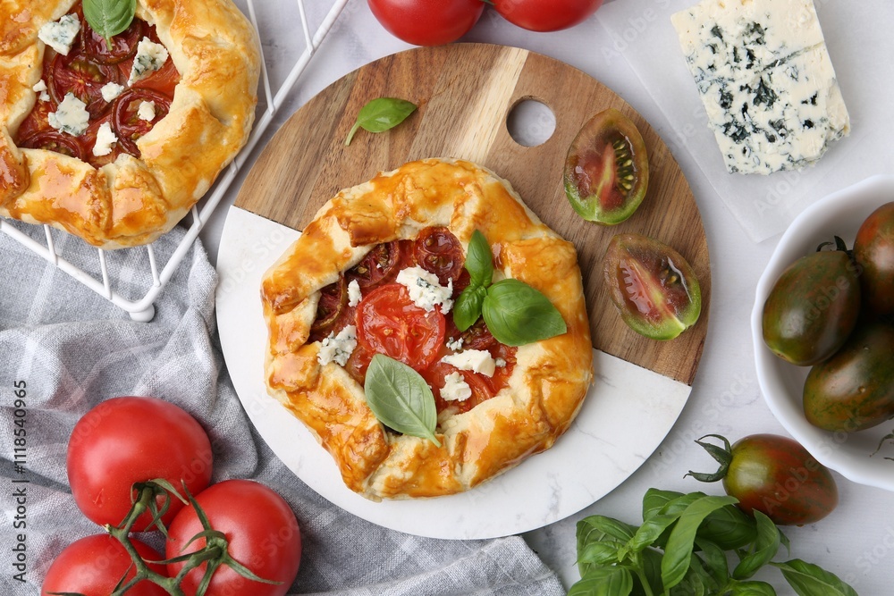 Tasty galettes with tomato, basil and cheese on white marble table, flat lay Tasty galettes with tomato, basil and cheese on white marble table, flat lay
