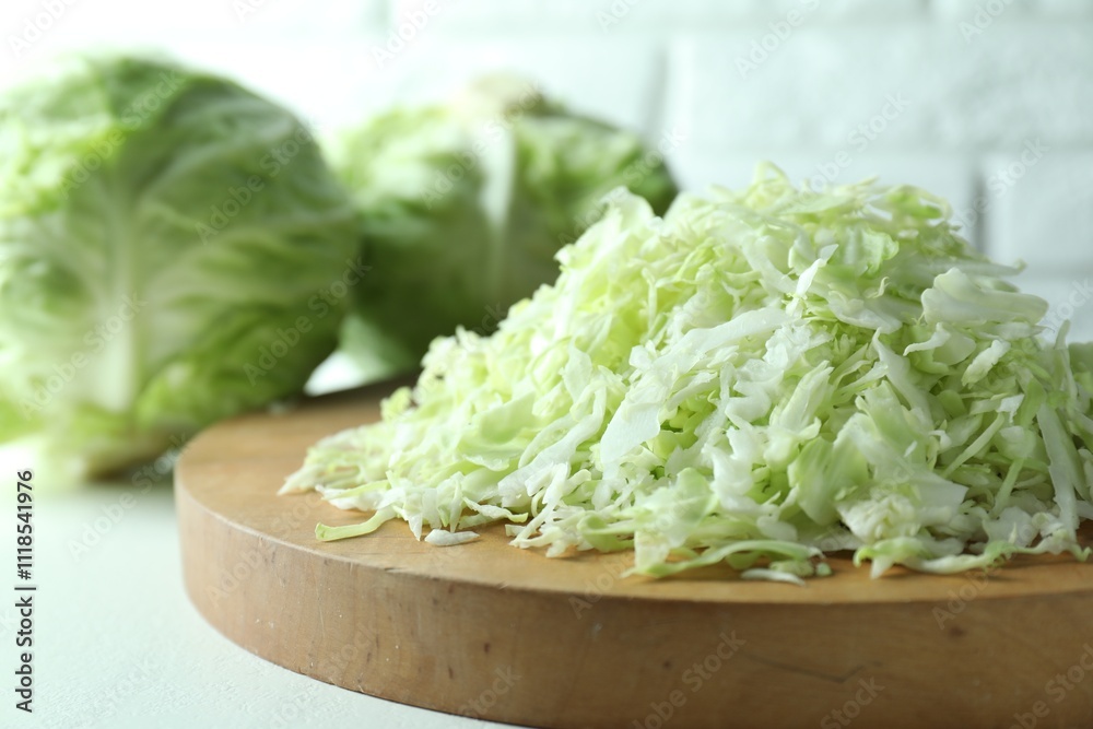 Fresh shredded cabbage on light table, closeup Fresh shredded cabbage on light table, closeup
