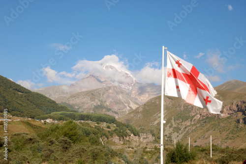 Obraz na płótnie Georgian flag against the backdrop of Mount Kazbek