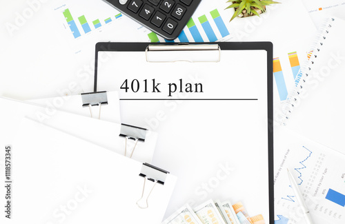 Text 401K Plan is written on a notebook with a pen and a magnifying glass lying on the table. Business concept. photo