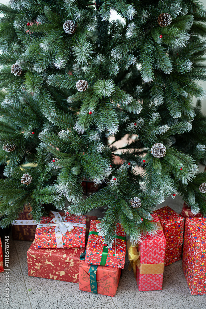 Merry x-mas,Close up of multiple gift boxes,Colorful balls and Christmas greeting picture parcel,Santa doll decoration on Green Christmas tree background Decoration During Christmas and New Year.