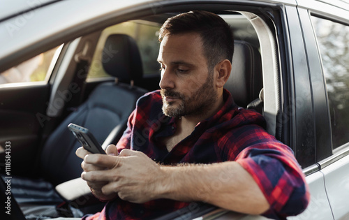 Man driving car and using phone