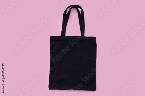 Black cotton, canvas, tote, mesh bag on light pink background. Zero waste, no plastic,eco friendly shopping recycling concept. Blank mockup shopper with place for artwork or text. Flat lay, copy space photo