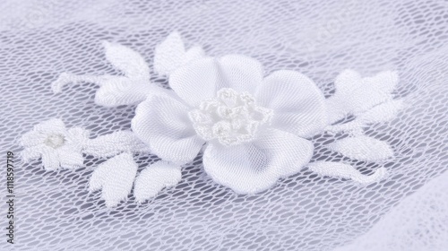 Delicate white flower applique on sheer fabric.