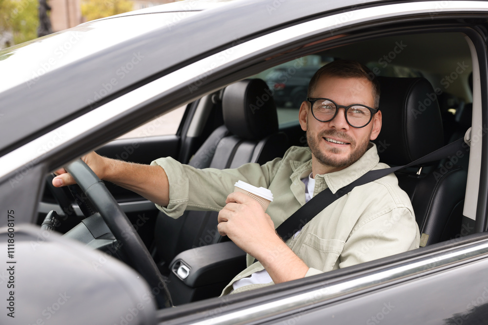 Man with cup of coffee driving modern car Man with cup of coffee driving modern car