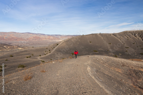 Hiker on the crater rim trail at Death Valley National Park, California photo