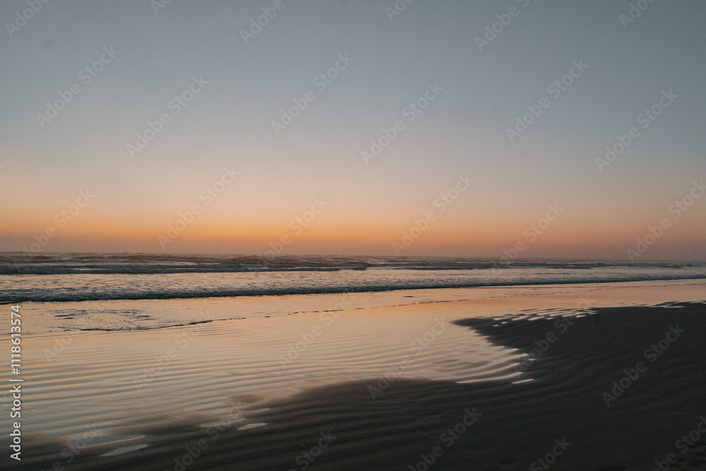 Fototapeta premium sunset on the beach with sand and reflections