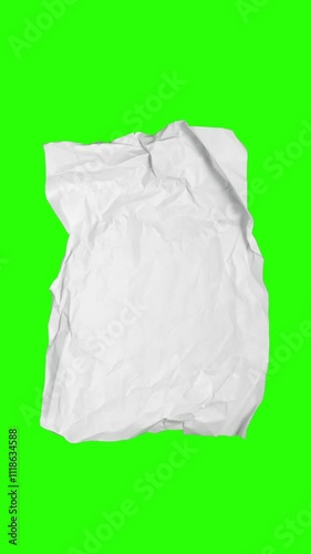 Stop motion animation of crumpled paper on a green background
