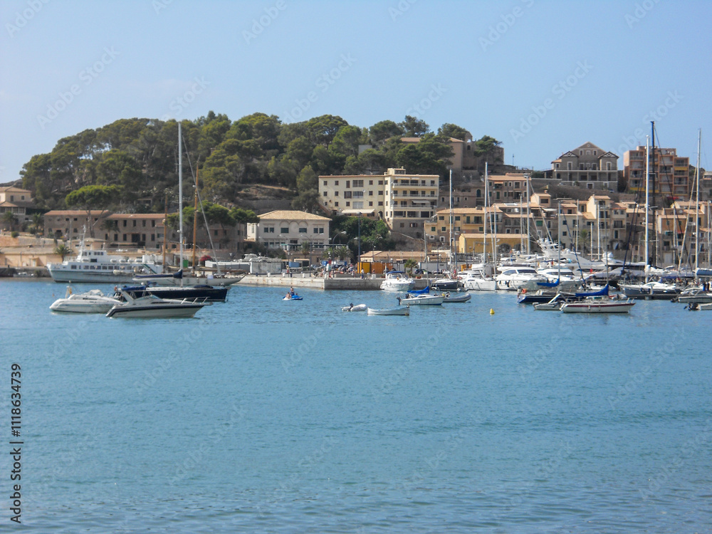 Boats docked at a scenic harbor near a hillside Boats docked at a scenic harbor near a hillside