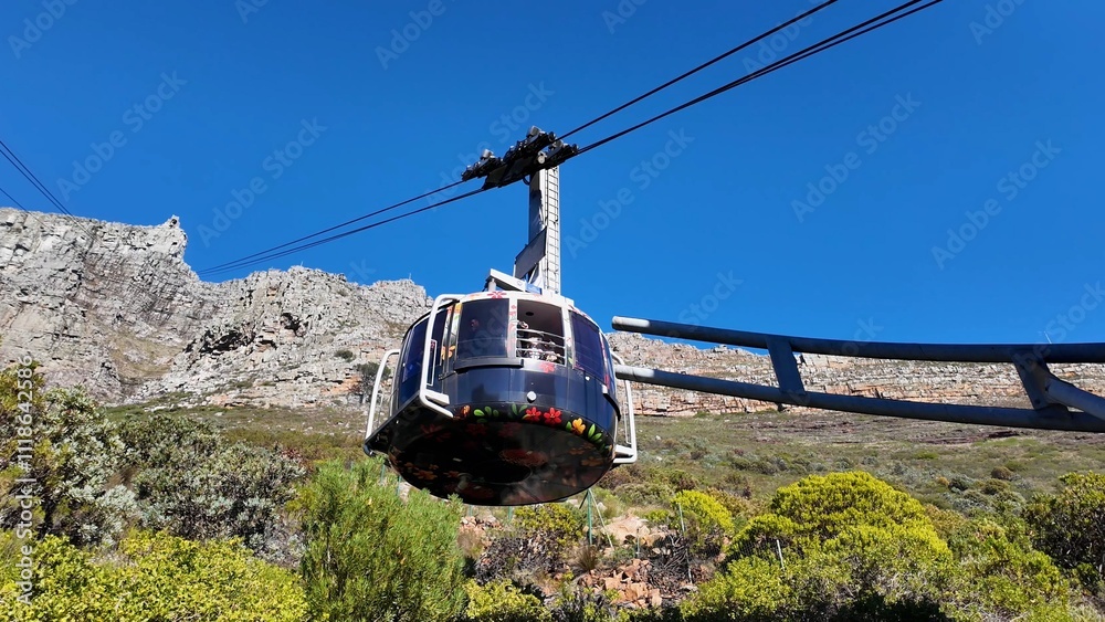 Fototapeta premium Cable Car Scene At Cape Town In Western Cape South Africa. Aerial Cableway Landscape. Giant Canyons. Cape Town At Western Cape South Africa. Tourism Travel. Table Mountain Skyline.