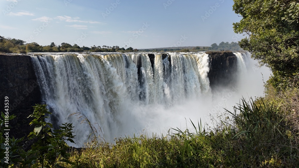 Famous Falls At Victoria Falls In Matabeleland North Zimbabwe. Giant Waterfalls. Nature Landscape. Victoria Falls At Matabeleland North Zimbabwe. Zambezi River. Travel Scenery. Famous Falls At Victoria Falls In Matabeleland North Zimbabwe. Giant Waterfalls. Nature Landscape. Victoria Falls At Matabeleland North Zimbabwe. Zambezi River. Travel Scenery.