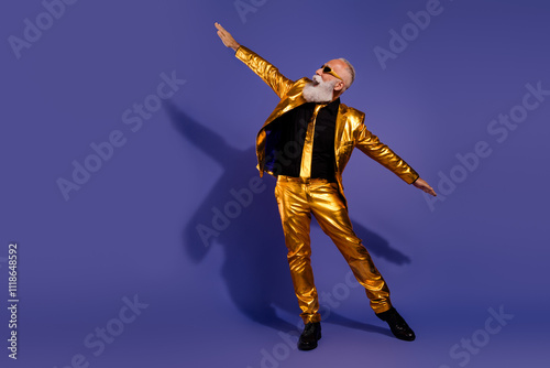 Full size photo of old macho man dancing look empty space spread hands dressed glamour golden outfit party isolated on purple background