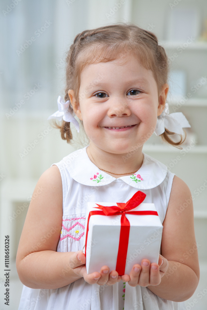 Portrait of little cute girl with Christmas present