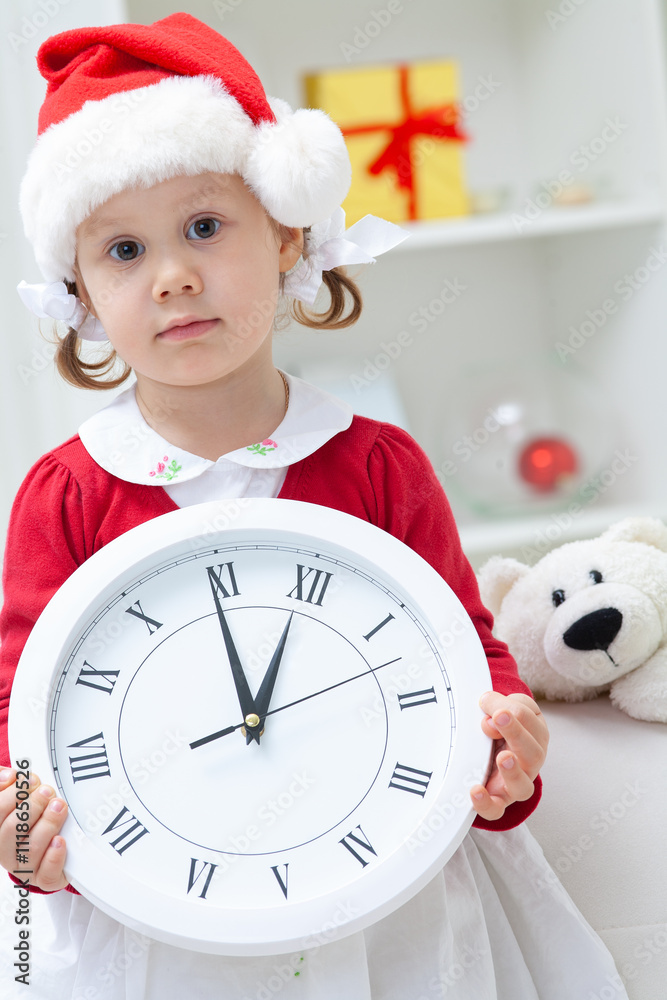 Portrait of little cute girl in Santa Claus costume with Christmas night