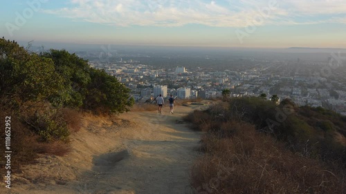Los Angeles, California - December 3, 2024: Hikers enjoying scenic views of Los Angeles from the trails of Runyon Canyon Park during a clear day.