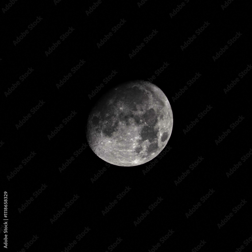 Full moon glowing brightly in a clear night sky above a serene landscape