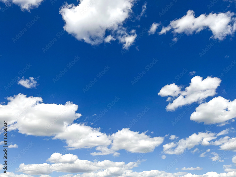 Bright blue sky filled with fluffy white clouds during a sunny day in summer Bright blue sky filled with fluffy white clouds during a sunny day in summer