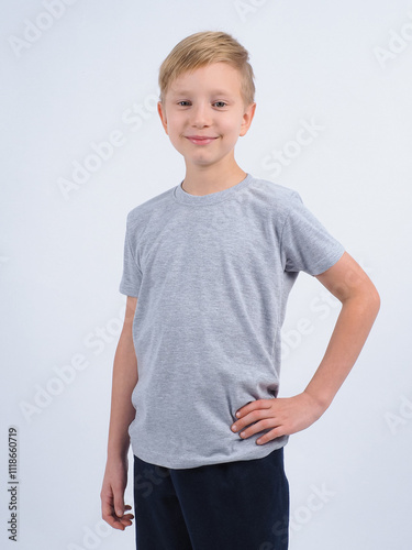 T-shirt design concept. Teen boy in blank gray t-shirt, isolated on white background.