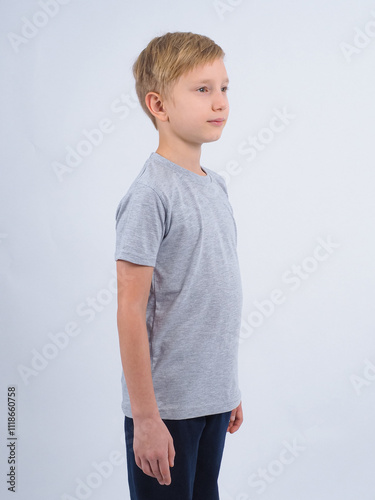 T-shirt design concept. Teen boy in blank gray t-shirt, isolated on white background.