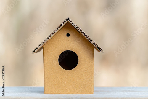 Cardboard recycle and repurpose concept. A handcrafted cardboard birdhouse made from recycled materials, showcasing eco-friendly craftsmanship and creativity in sustainable design. photo