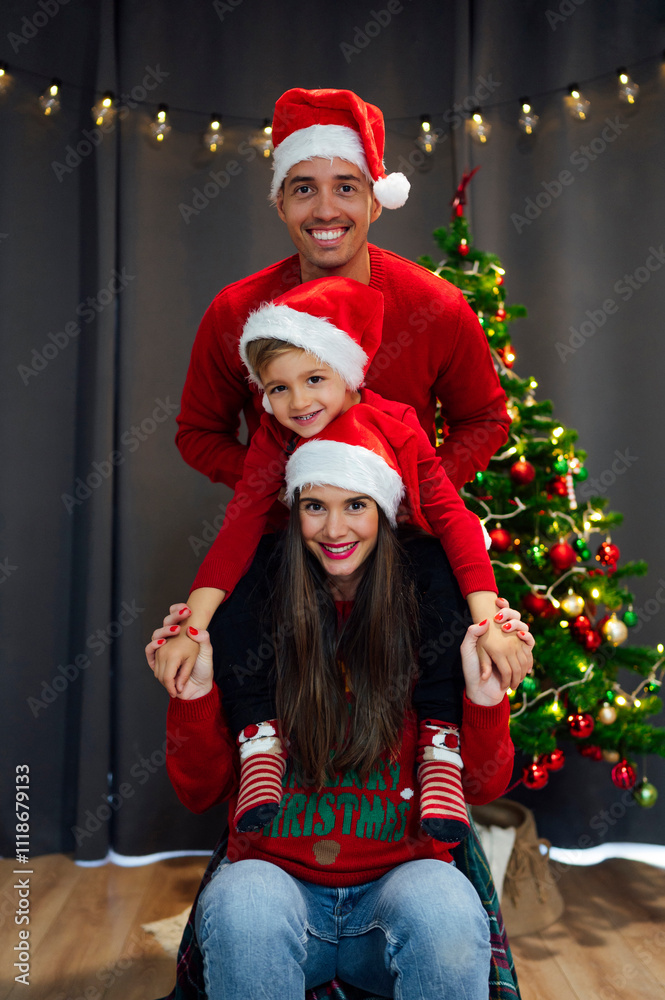 Fototapeta premium Happy family at christmas with santa claus hat