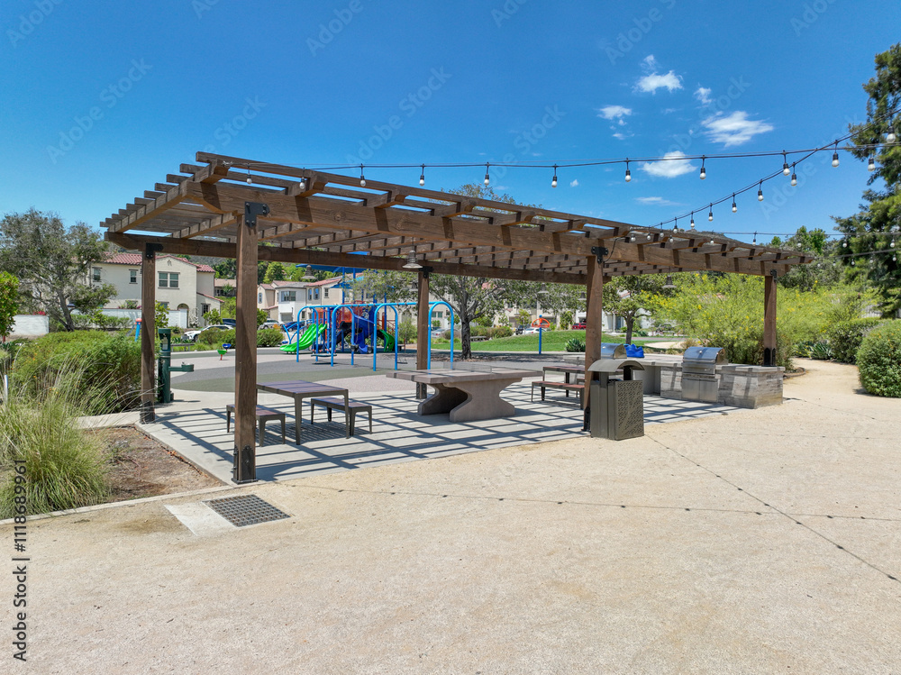 Covered gathering area in community park with picnic tables, Escondido, San Diego, California