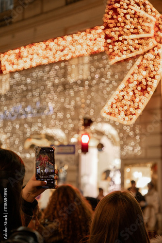 Vienna, Austria: taking photos with the cellphone of the christmas decoration and christmas lights in the city center photo