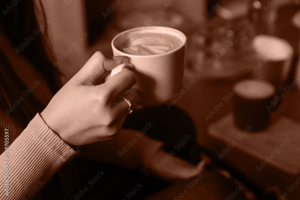 A hand holding a cup of coffee frames the earthy aesthetic. Pantone 2025 Color of the Year Mocha Mousse inspired design featuring a warm coffee-brown tone A hand holding a cup of coffee frames the earthy aesthetic. Pantone 2025 Color of the Year Mocha Mousse inspired design featuring a warm coffee-brown tone