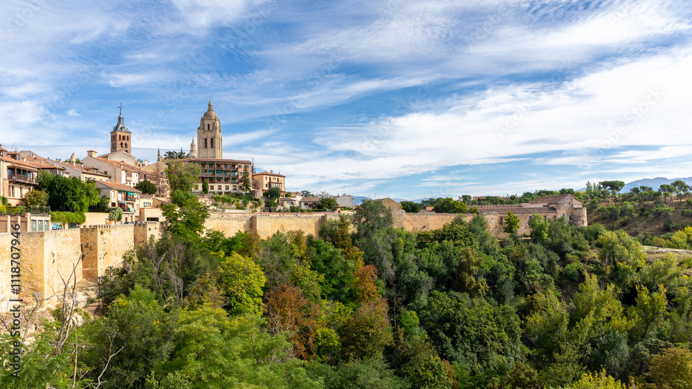Segovia, Spain, high resolution panorama of the city with Segovia Cathedral, bell towers, medieval architecture, city walls, green vegetation around. Segovia, Spain, high resolution panorama of the city with Segovia Cathedral, bell towers, medieval architecture, city walls, green vegetation around.
