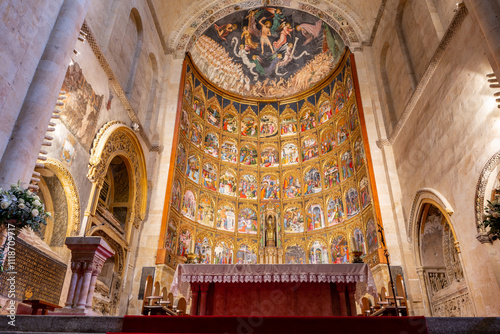 The main altarpiece of the Old Cathedral (Catedral Vieja) in Salamanca, Spain with tables and icons showing life of Jesus, richly decorated golden artwork.