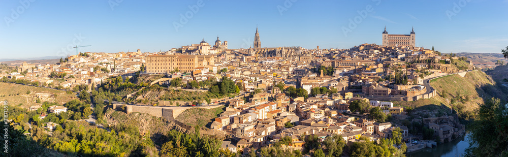 Toledo (Spain) panorama of the medieval city with Alcazar of Toledo, Toledo Cathedral, churches and residential buildings on a hill with Tagus river below, seen from Mirador del Valle. Toledo (Spain) panorama of the medieval city with Alcazar of Toledo, Toledo Cathedral, churches and residential buildings on a hill with Tagus river below, seen from Mirador del Valle.
