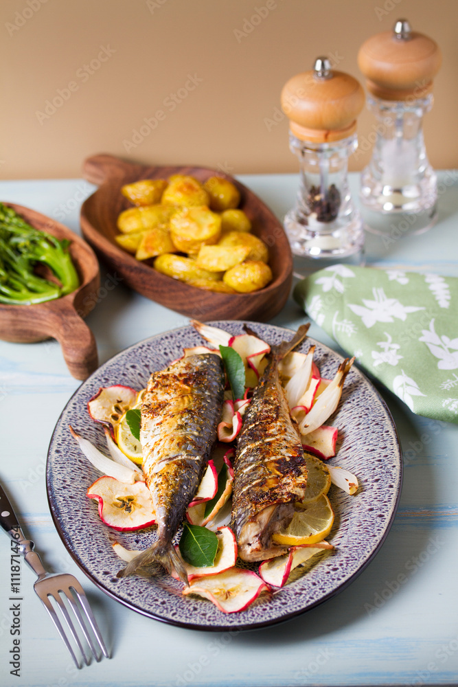 Grilled mackerel fish with roasted potatoes and broccoli. View from above, top studio shot