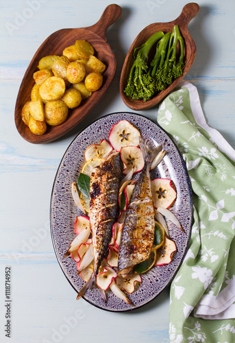 Grilled mackerel fish with roasted potatoes and broccoli. View from above, top studio shot